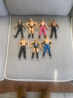 Lot of seven iconic wrestling action figures from the Jakks Pacific era,